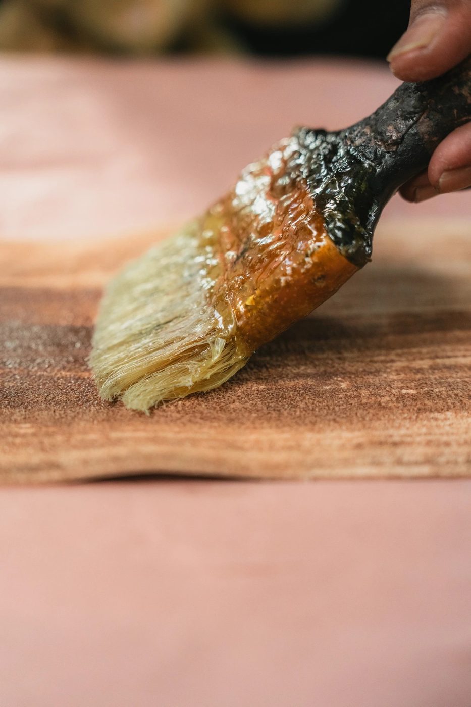 Applying adhesive to a leather surface with a small glue brush