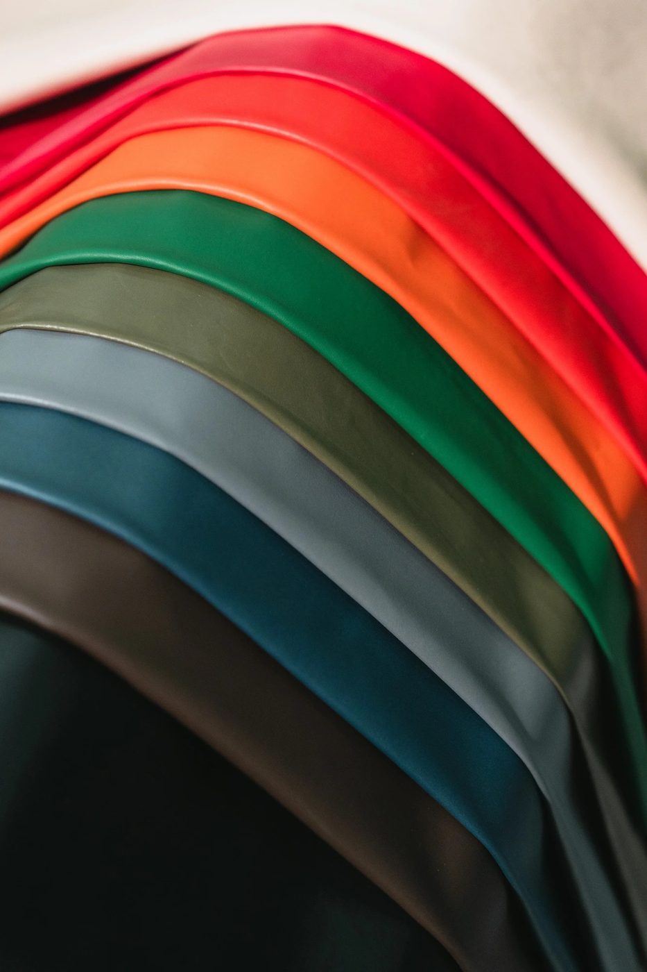 Stack of coloured leather hides in red, orange, green, blue, brown and black
