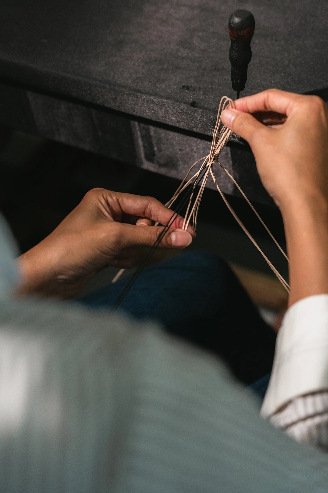Artisan hands braiding leather